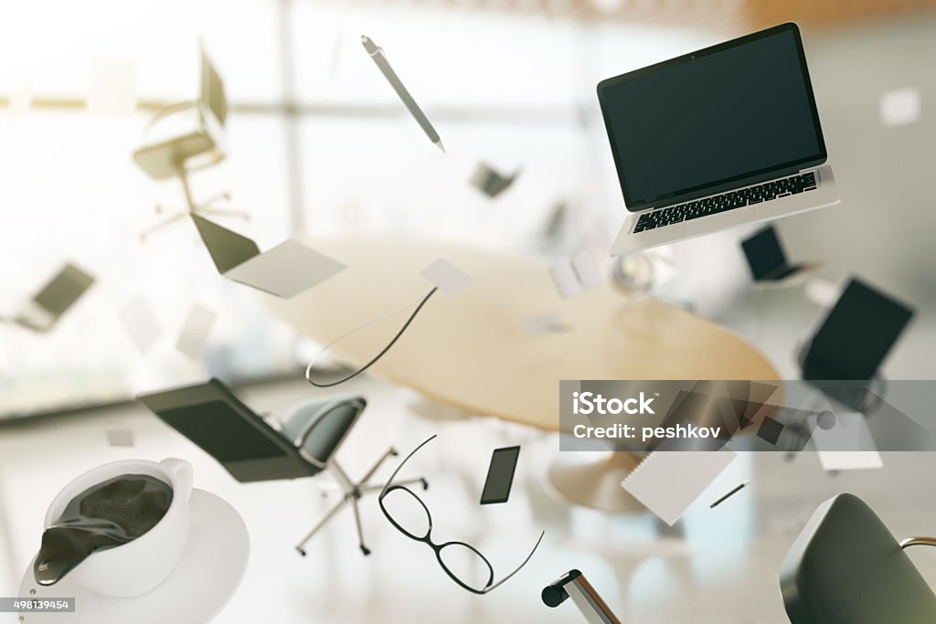 Concept of chaos in the office with flying objects Concept of chaos in the office with flying objects and furnishings Office Stock Photo
