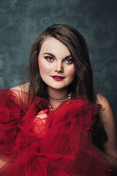 istock Beautiful elegant young woman in red 498139712