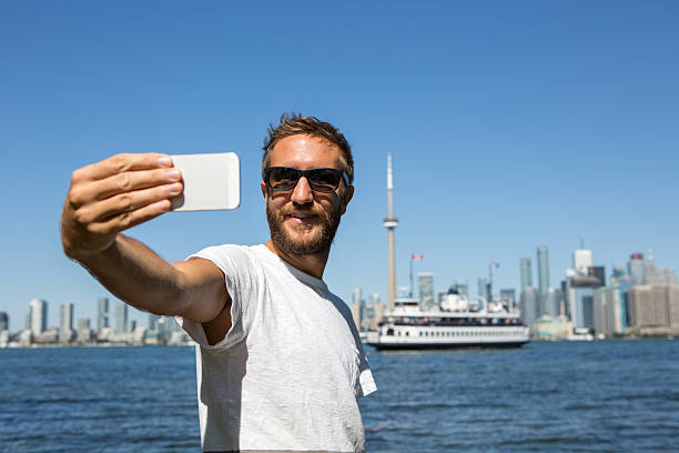 istock Young cheerful man in Toronto-Canada taking a selfie portrait 498142788