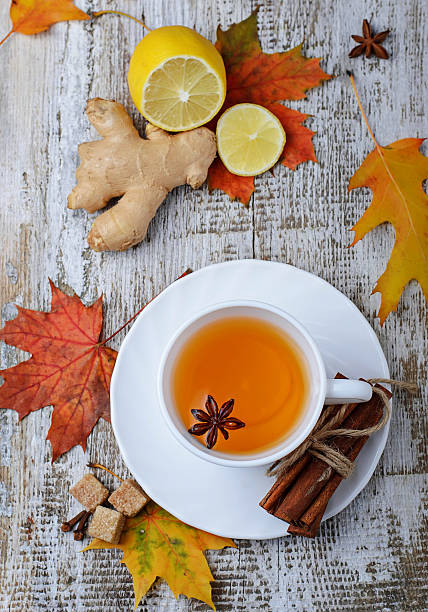 istock Ginger, lemon and cop of tea on light background 498145486