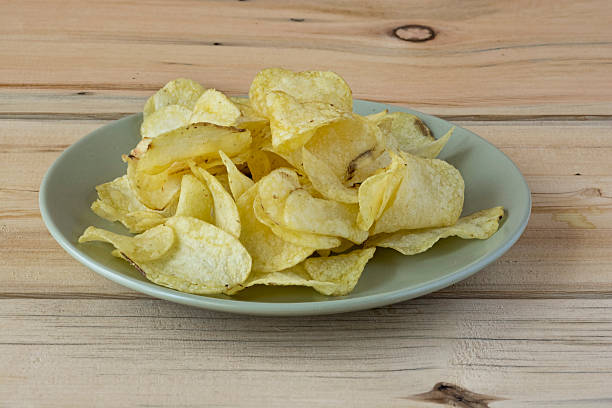 istock Some potato chips on a green plate on a wooden table 498146790