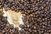 Map of Mexico under a background of coffee beans