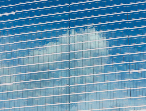 Abstract cloud reflection on building window.