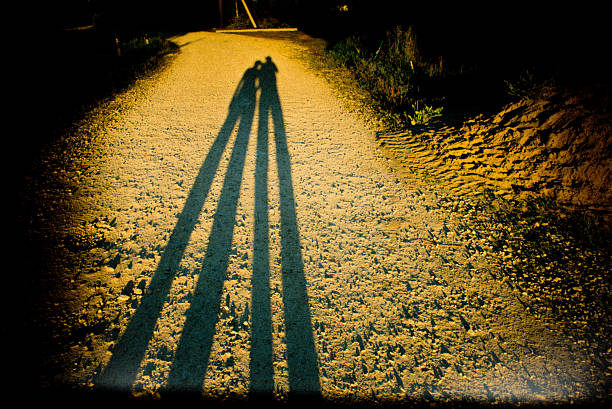 istock Long human shadows on a dirty road. 498149792