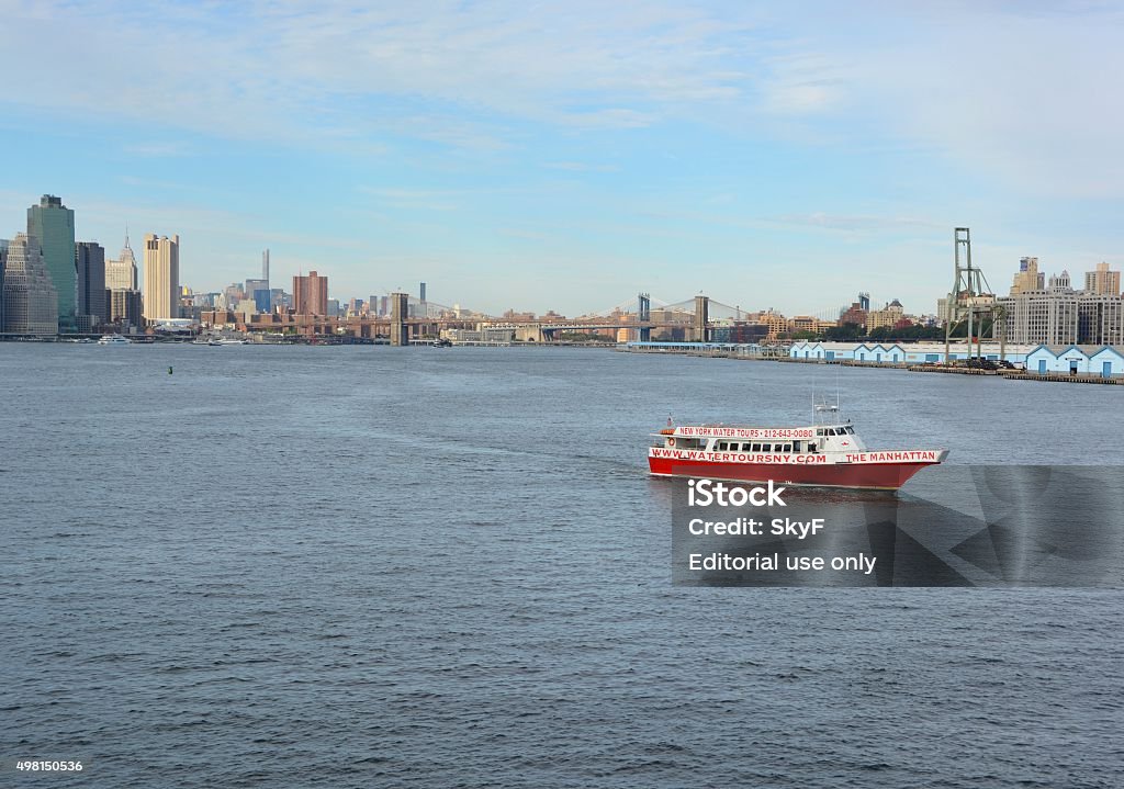 New York Water tours New York, NY USA - September 21, 2015: New York Water tours excursion boat crossing the Brooklyn harbor; Brooklyn Bridge and New York skyline in the background 2015 Stock Photo