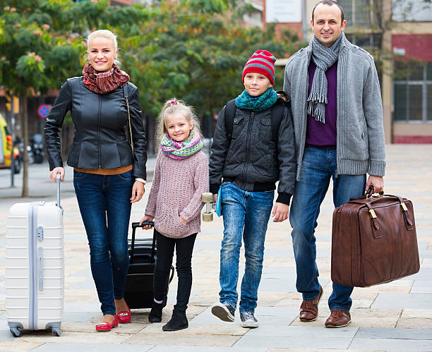 istock Parents with two kids  chasing streets 498151814