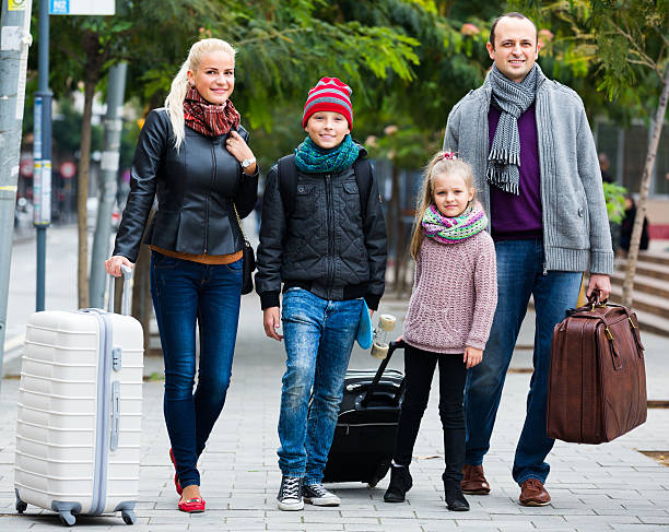 istock Parents with two kids  chasing streets 498151884
