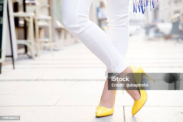 Women Wearing Yellow High Heels In The City Stock Photo - Download Image Now - High Heels, Women, White Color