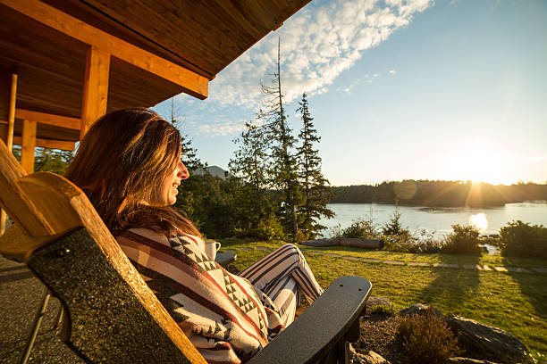 istock Young woman relaxing and watching sunrise 498169352