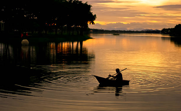 istock Silhouette of fisherman boating 498169423