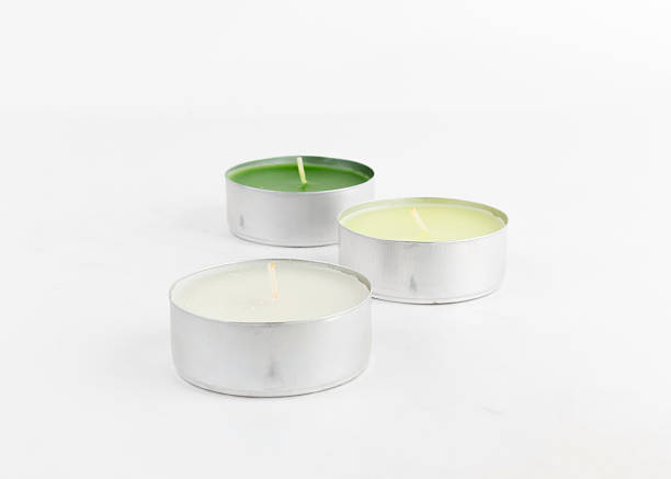 istock white cream and green candle on a white background. 498171813