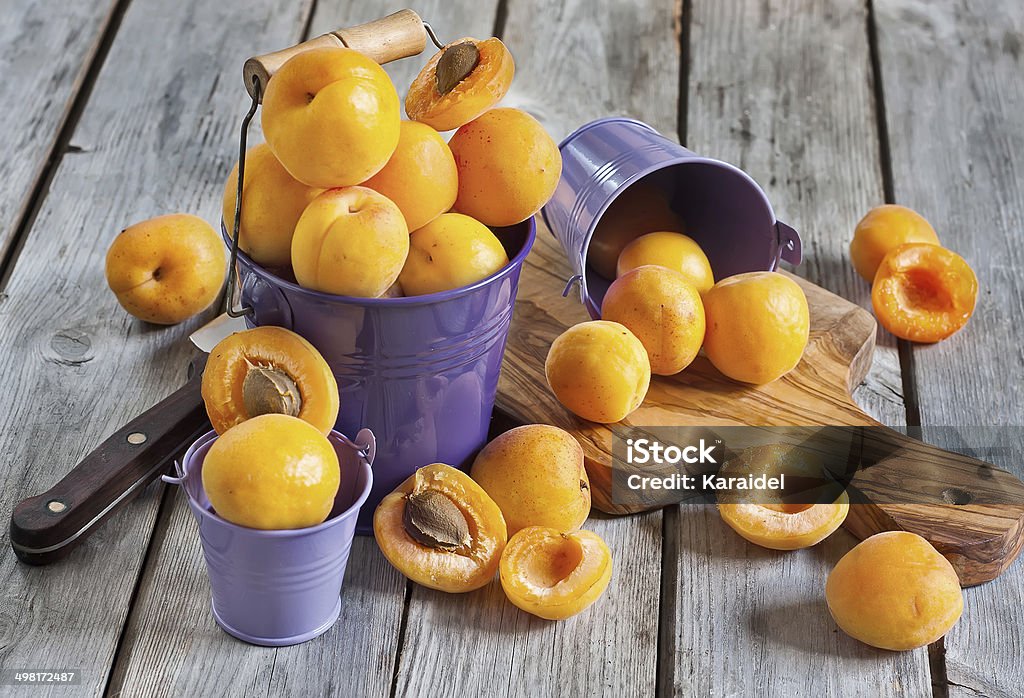 Apricots Sweet ripe apricots in small violet buckets. Selective focus. Agriculture Stock Photo