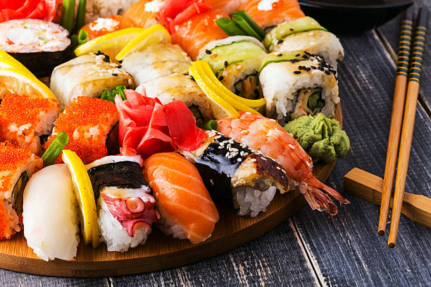 istock Sushi Set: sushi and sushi rolls on wooden plate. 498173518
