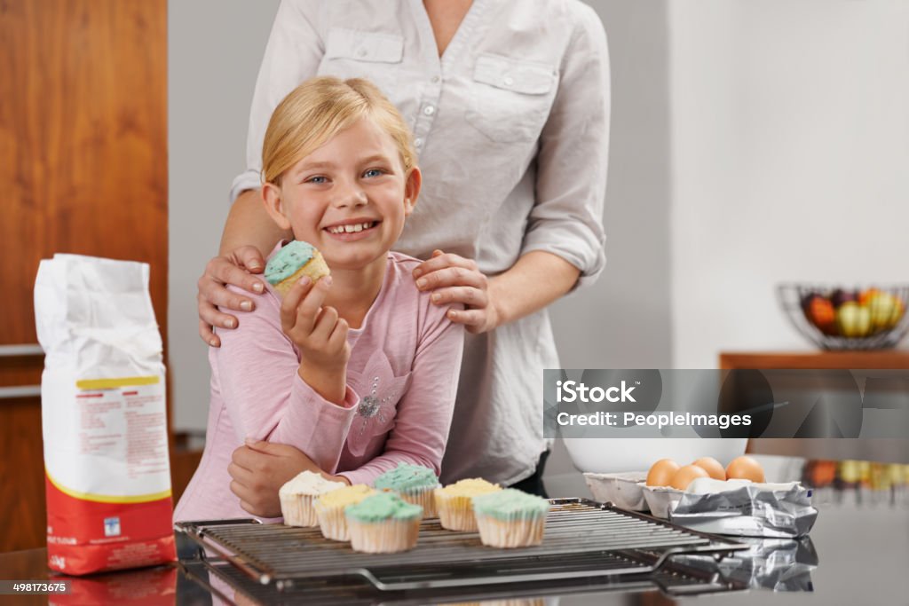 Yummy results Shot of an adorable little girl and her mom showing off the results of their bakinghttp://195.154.178.81/DATA/i_collage/pi/shoots/783288.jpg 6-7 Years Stock Photo