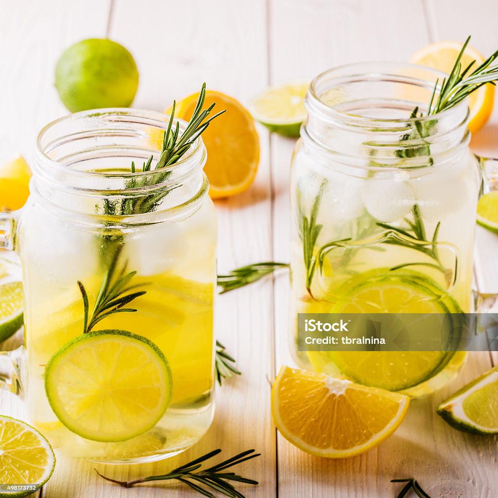 Homemade lemonade with lime, lemon, rosemary. Homemade lemonade with lime, lemon, rosemary in  mason jar on  wooden white background. 2015 Stock Photo