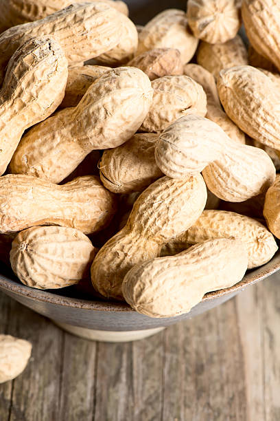 istock Peanuts in shell on wooden table in plate 498174107