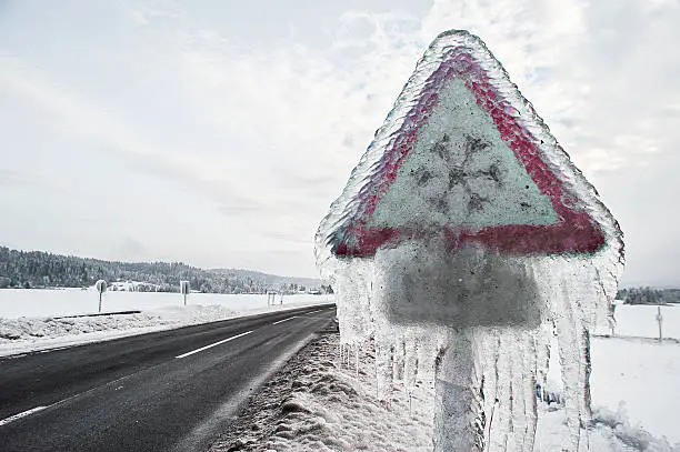 snow alert frozen sign on road