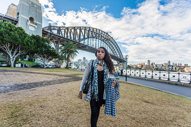 Modern Australian aboriginal woman by the Sydney Harbour Bridge