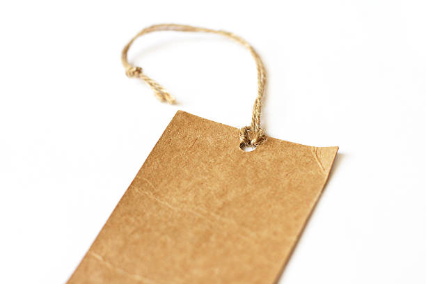 istock Cardboard empty blank tag fragment closeup on white background 498175727