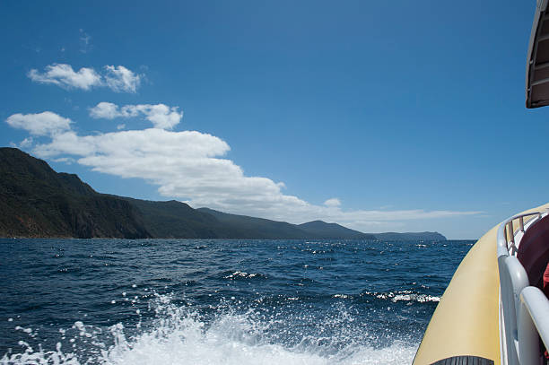 istock Sailing on boat remote steep cliff coast Tasmania 498186272