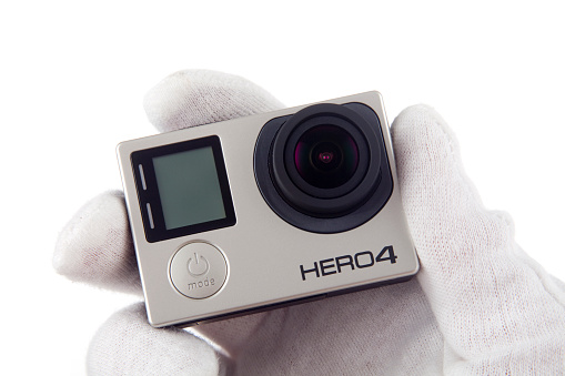 Zgierz, Poland - October 11, 2015: A GoPro HERO 4 Black edition photographed on a white background. In September 2014 GoPro announced the HERO4 camera, available in Black Edition and Silver Edition, which replace their respective Hero3+ generation cameras.