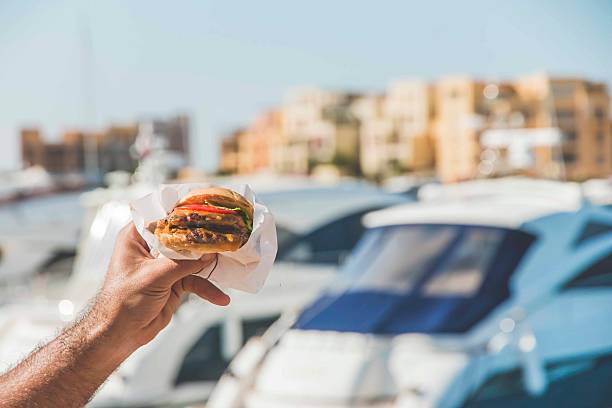 Hamburger is a fast food make from bun, meat, cheese and vegetable  in fastfood restaurant, unhealthy food or fat concept