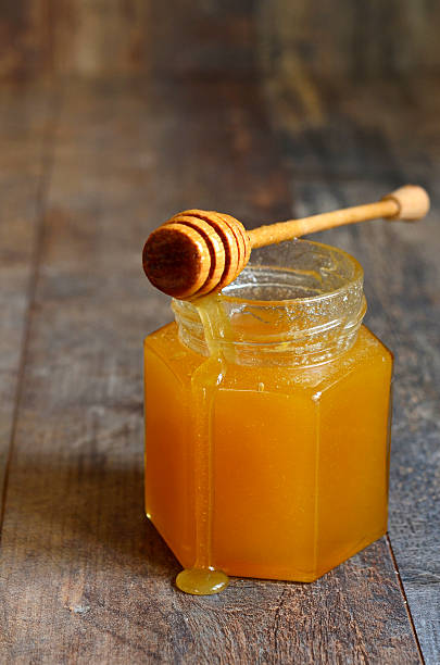 istock Honey in a glass jar. 498197128