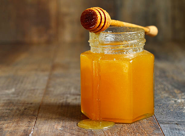 istock Honey in a glass jar. 498197352