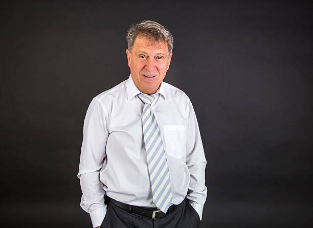 istock handsome businessman on black background 498198882