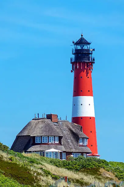 Photo of Lighthouse with Thatched Roof House