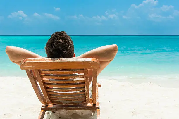 Photo of Young man resting on beach