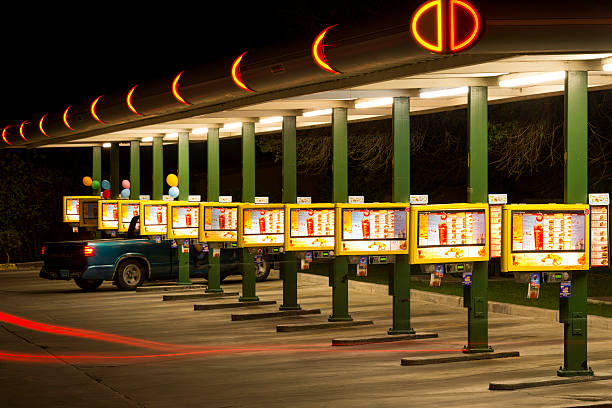 Route 66 Sonic Drive-In Restaurant - Albuquerque New Mexico Albuquerque, New Mexico, USA - April 17, 2012: Neon lights and lighted menus and booths with pickup-truck at Sonic Drive-In Restaurant on Route 66 at night. bernalillo county stock pictures, royalty-free photos & images