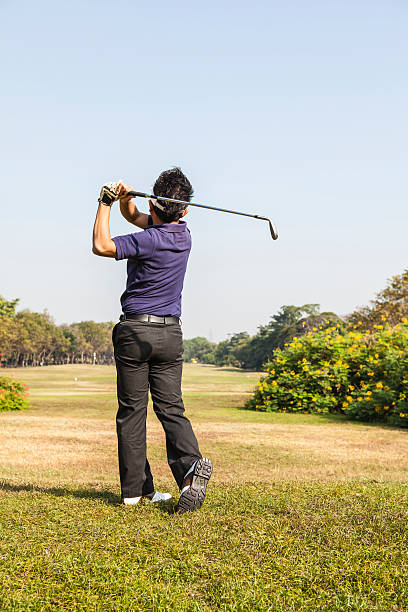 istock Male player teeing off golf ball from tee box 498209619