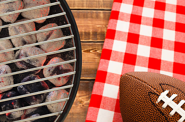 Football Tailgate Party Grill with glowing charcoal briquettes and football tailgate party photos stock pictures, royalty-free photos & images