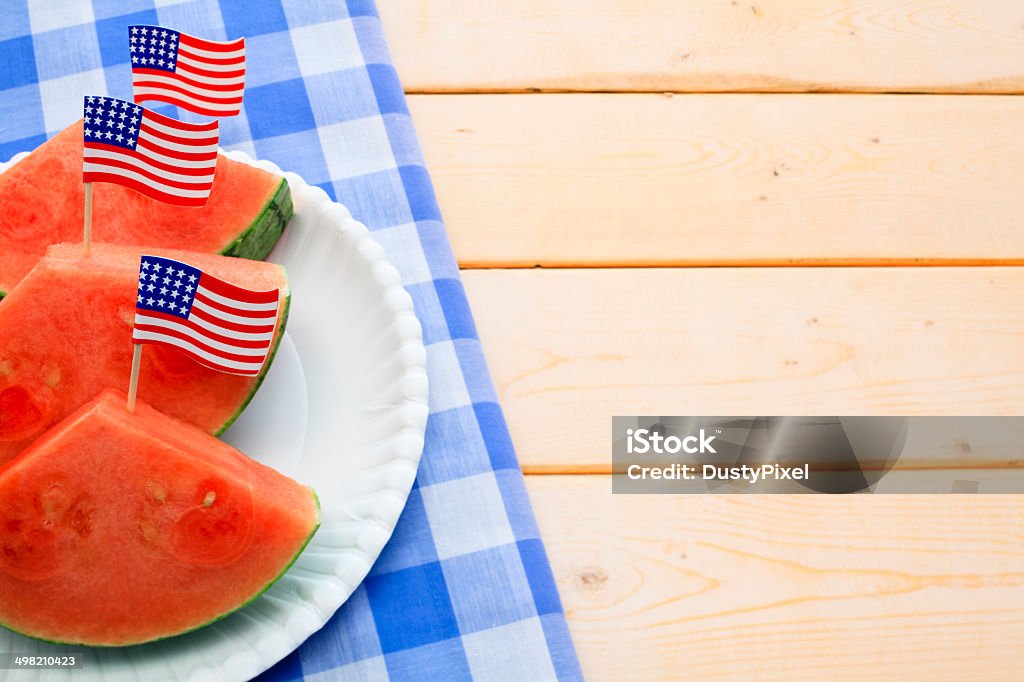 Fourth of July Picnic Slices of watermelon on a picnic table with traditional blue checked table cloth American Culture Stock Photo