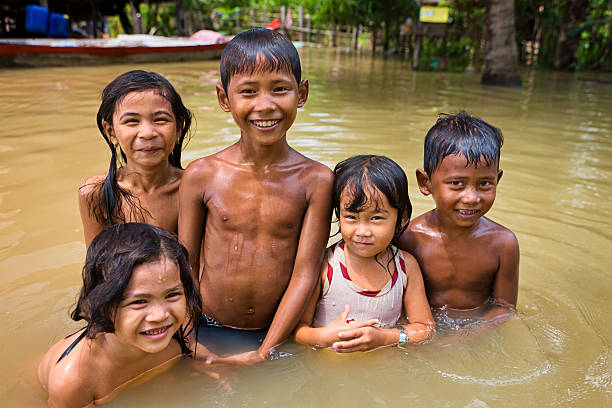 istock Children having fun in the water during flood, Cambodia 498210457