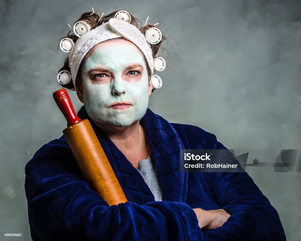 Mean and ugly housewife Mean and ugly housewife with facial mask, hair rollers and rolling pin Women Stock Photo
