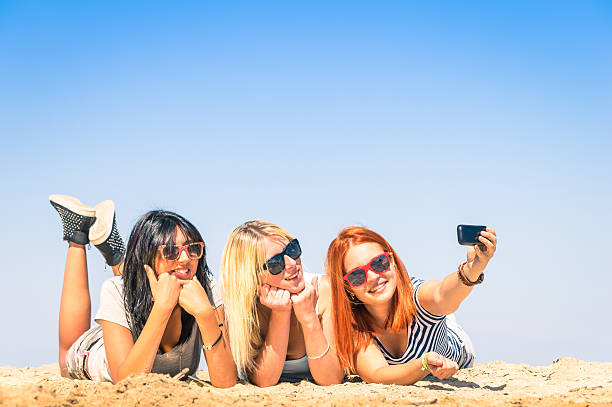 istock Group of girlfriends taking a selfie at the beach 498211745