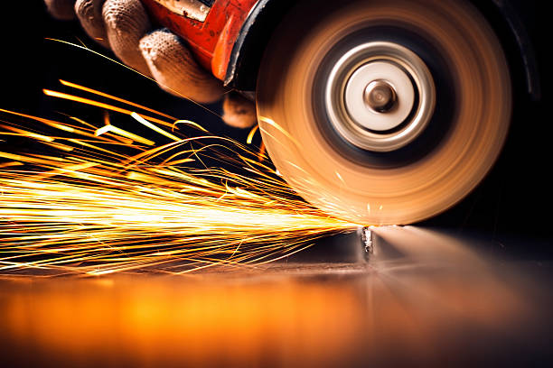 istock Worker cutting metal with grinder. Sparks while grinding iron 498213265