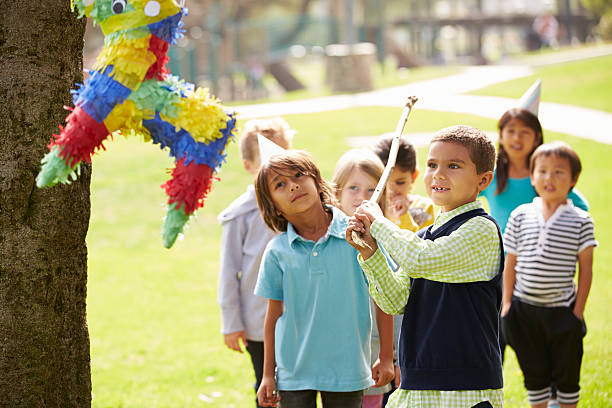 istock Children Hitting Pinata At Birthday Party 498213899