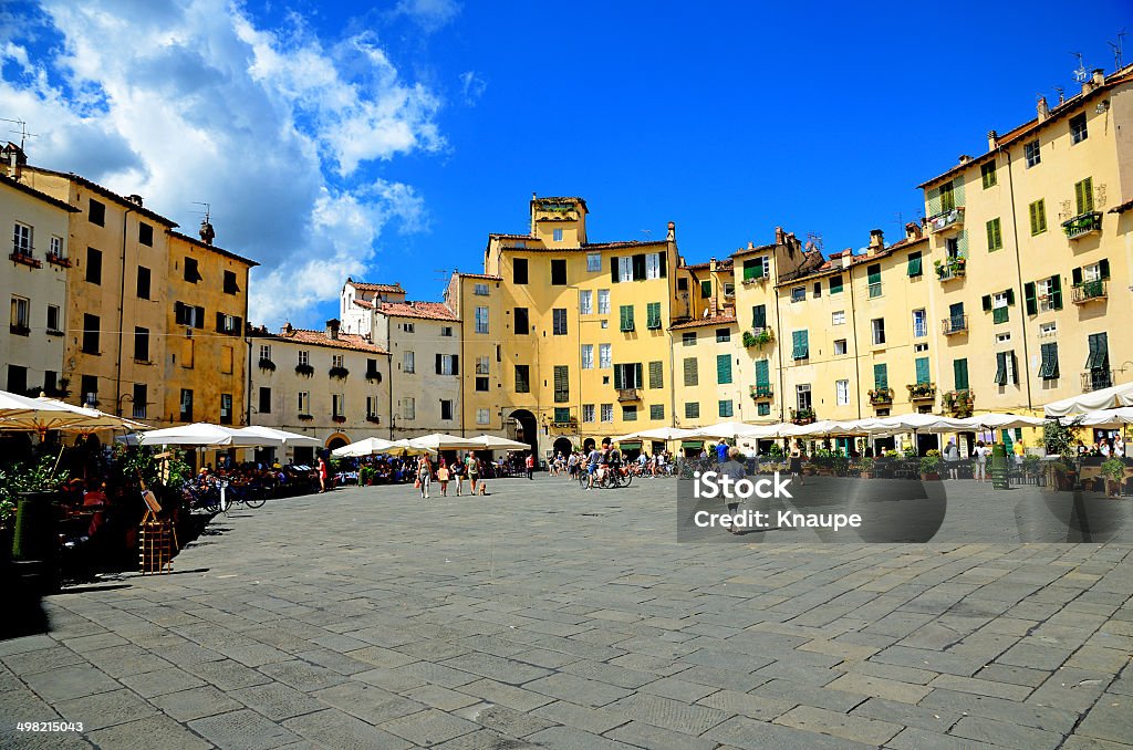 Piazza Amphitheater in Lucca Piazza Anfiteatro in central Lucca, surrounded by little restaurants and cafe's, popular by tourists in the city. The place is also known as Piazza del Mercator. It is based on an old roman amphitheater. Lucca Stock Photo