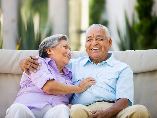 istock Mexican senior couple sitting together 498238535