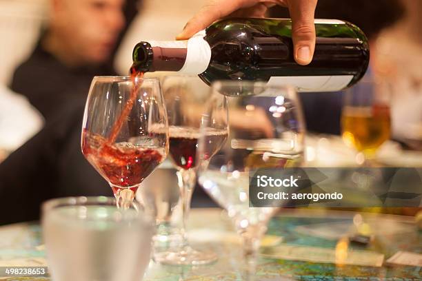 Waiter Pouring Red Wine Into Glasses Stock Photo - Download Image Now - Alcohol - Drink, Bar - Drink Establishment, Bottle