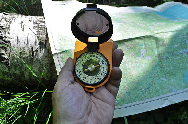 istock Compass in hand, against background of the map. 498238835