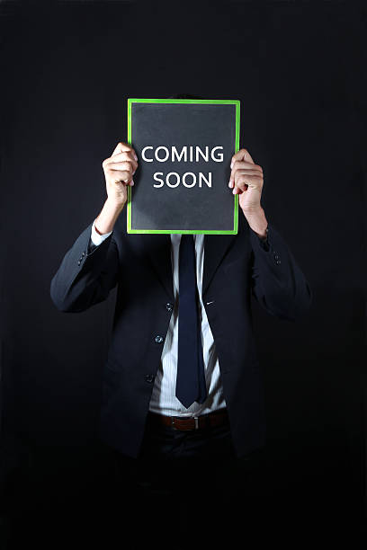istock Businessman with coming soon written on slate 498240871