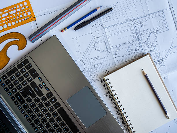 istock Top view of architectural blueprint with tools and laptop 498242629
