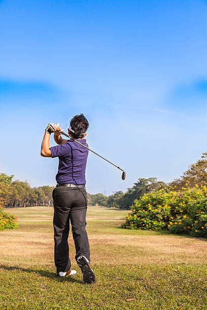 istock Male player teeing off golf ball from tee box 498244407