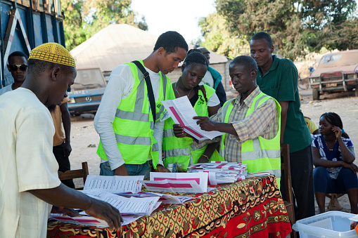 Gabu, Guinea-Bissau - April 13, 2014: Polling station, ballot boxes and international election observer in rural Guinea-Bissau during general elections in 2014.