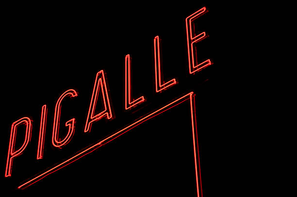 Pigalle sign in Paris on black background Paris, France - March 12, 2010: Red neon sign of Pigalle at night, worldwide known place in Paris near cabaret Moulin Rouge at night. France place pigalle stock pictures, royalty-free photos & images