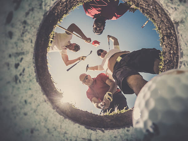 istock Point Of View Golf Players and Ball From Inside Hole 498250392